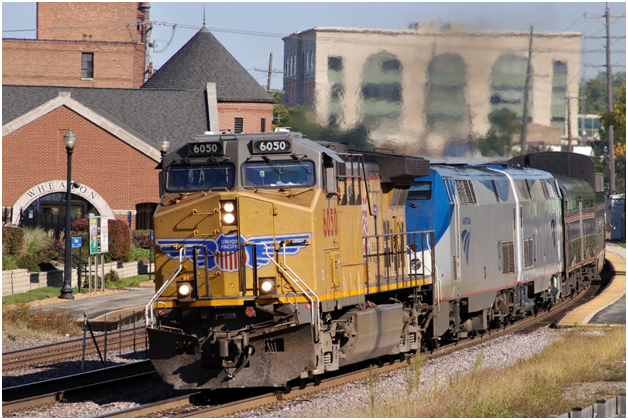 In a press release dated today, the Federal Railroad Administration announced the intent to regulate crew sizes of both freight and passenger trains. In October of 2011, a Union Pacific freight locomotive assisted Amtrak passenger locomotives pulling train #5, the “California Zephyr” via a special detour routing through Wheaton, Illinois in suburban Chicago. (photo copyright 2011 by Paul Burgess, all rights reserved)