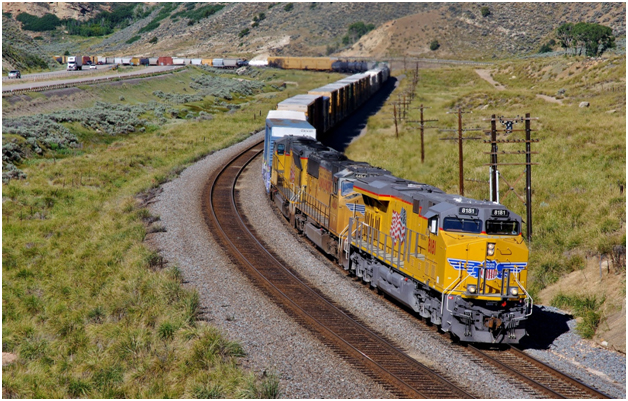A freight train like this Union Pacific manifest rolling along I-80 in Utah’s Echo Canyon may have a plethora of hazardous materials as part of its lading; so may the truck on the adjacent interstate. An Emergency Response Guidebook can be a vital tool to help emergency responders take proper action if trouble strikes. (©Paul Burgess August 2014; used with permission)